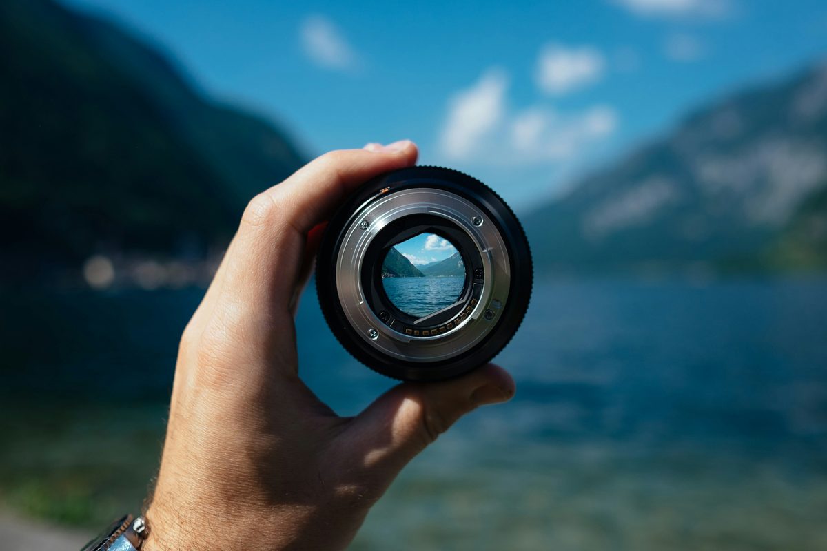 A camera lens bringing a distant landscape into sharp focus